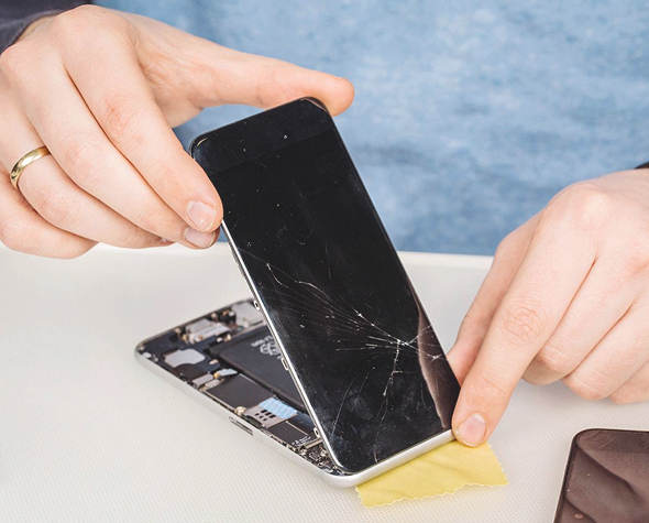A man fixing a broken phone