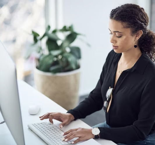 A woman using an iMac computer